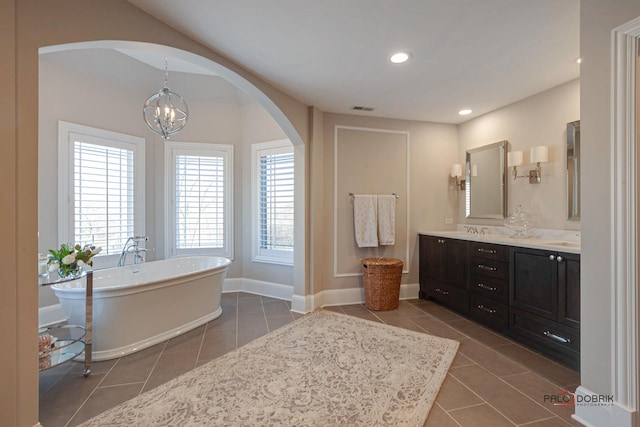 38868 Oakcrest Ln, Wadsworth, IL 60083 - full bath with tile patterned floors, double vanity, a soaking tub, a chandelier, and recessed lighting