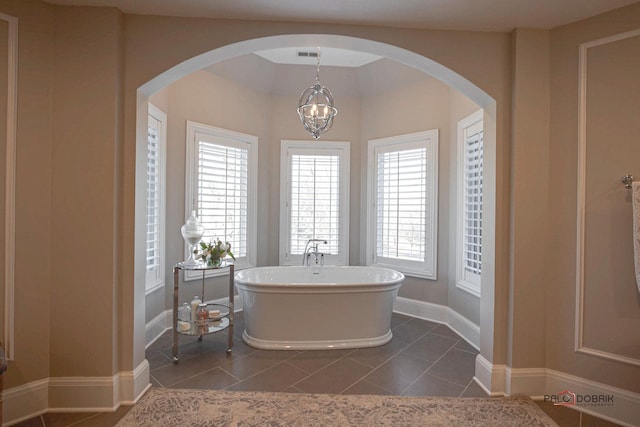 38868 Oakcrest Ln, Wadsworth, IL 60083 - full bathroom with a freestanding bath, tile patterned flooring, a chandelier, and baseboards