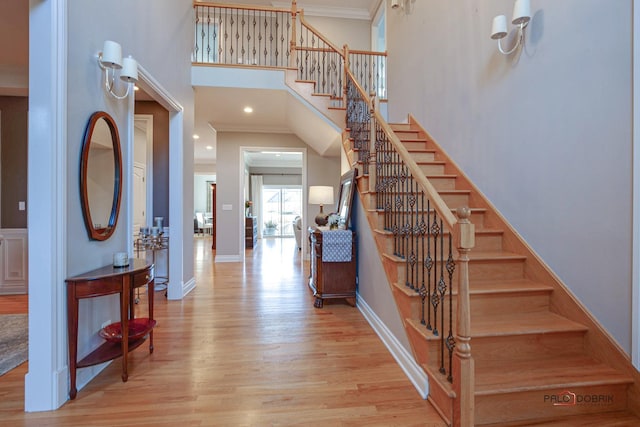 38868 Oakcrest Ln, Wadsworth, IL 60083 - staircase with wood finished floors, a towering ceiling, crown molding, and baseboards