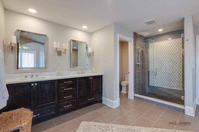 38868 Oakcrest Ln, Wadsworth, IL 60083 - bathroom with double vanity, toilet, a stall shower, baseboards, and tile patterned flooring
