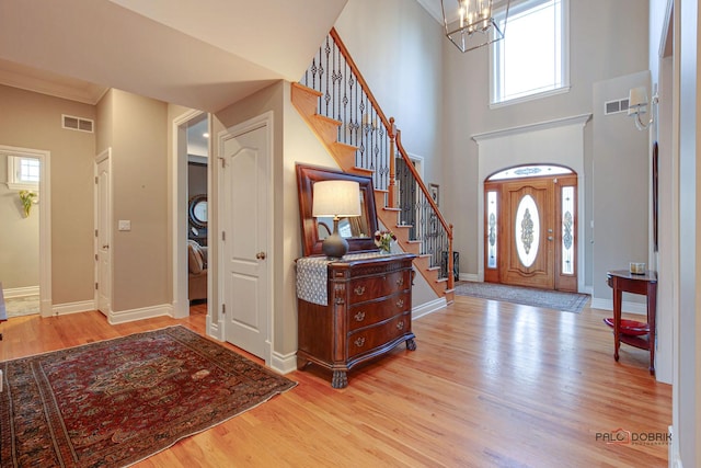 38868 Oakcrest Ln, Wadsworth, IL 60083 - foyer with a chandelier, stairway, wood finished floors, baseboards, and a high ceiling