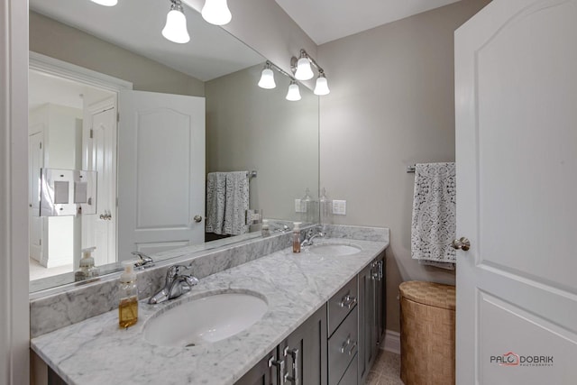 38868 Oakcrest Ln, Wadsworth, IL 60083 - bathroom featuring double vanity, tile patterned floors, and baseboards