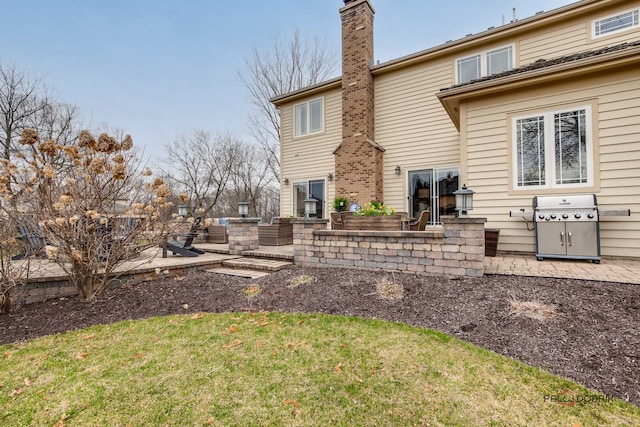 38868 Oakcrest Ln, Wadsworth, IL 60083 - rear view of property featuring a chimney, a lawn, and a patio area