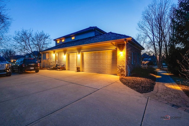 38868 Oakcrest Ln, Wadsworth, IL 60083 - property exterior at dusk featuring concrete driveway and a garage