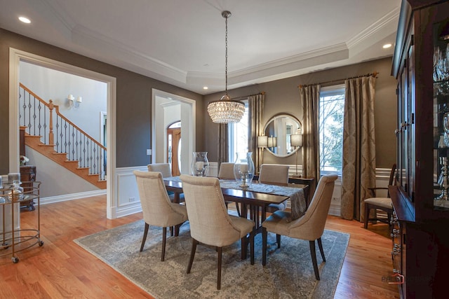 38868 Oakcrest Ln, Wadsworth, IL 60083 - dining room with ornamental molding, a raised ceiling, a chandelier, light wood-style flooring, and stairs