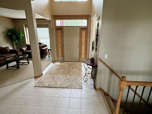 1849 Moorland Ln, Crystal Lake, IL 60014 - entrance foyer featuring baseboards, light tile patterned flooring, a towering ceiling, and light carpet