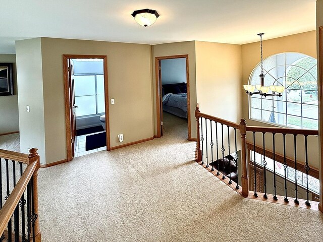 1849 Moorland Ln, Crystal Lake, IL 60014 - corridor featuring carpet floors, an upstairs landing, a chandelier, and baseboards