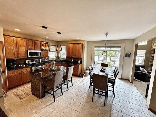 1849 Moorland Ln, Crystal Lake, IL 60014 - kitchen featuring appliances with stainless steel finishes, healthy amount of natural light, tasteful backsplash, brown cabinets, and recessed lighting