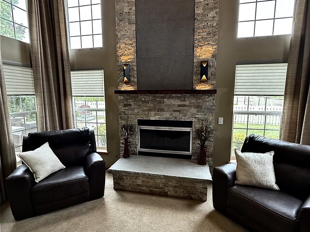 1849 Moorland Ln, Crystal Lake, IL 60014 - living room with healthy amount of natural light, carpet floors, a stone fireplace, and a towering ceiling