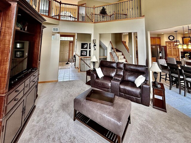 1849 Moorland Ln, Crystal Lake, IL 60014 - living room featuring light carpet, a towering ceiling, stairway, and baseboards