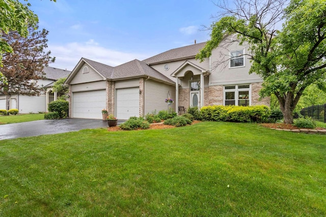 857 Bluestem Dr, Bolingbrook, IL 60440 - traditional home featuring driveway, an attached garage, brick siding, and a front lawn