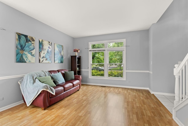 857 Bluestem Dr, Bolingbrook, IL 60440 - living room with light wood-style flooring, baseboards, and stairs