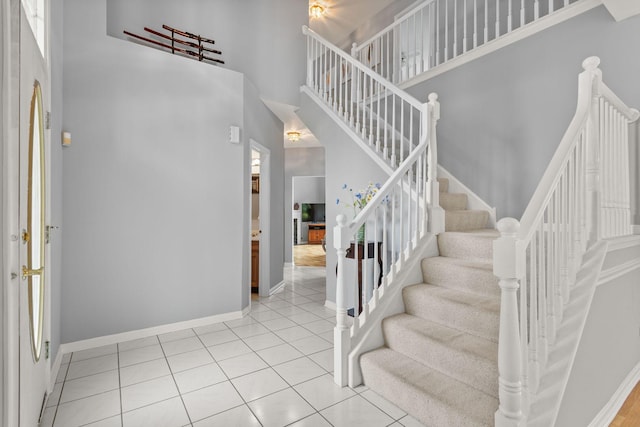 857 Bluestem Dr, Bolingbrook, IL 60440 - entrance foyer featuring a towering ceiling, baseboards, stairway, and tile patterned flooring