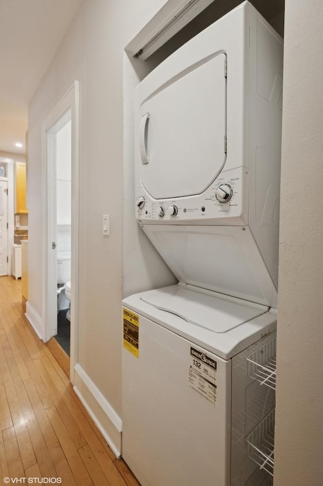 1620 W Olive Ave Unit 3A, Chicago, IL 60660 - washroom with estacked washer and dryer, light wood-style flooring, and baseboards
