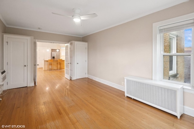 1620 W Olive Ave Unit 3A, Chicago, IL 60660 - spare room featuring radiator heating unit, light wood-style flooring, baseboards, ceiling fan, and ornamental molding