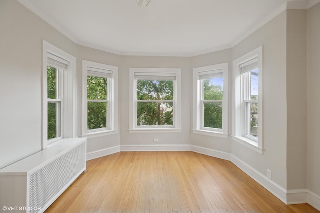 1620 W Olive Ave Unit 3A, Chicago, IL 60660 - unfurnished sunroom featuring radiator heating unit, wood-type flooring, crown molding, and baseboards