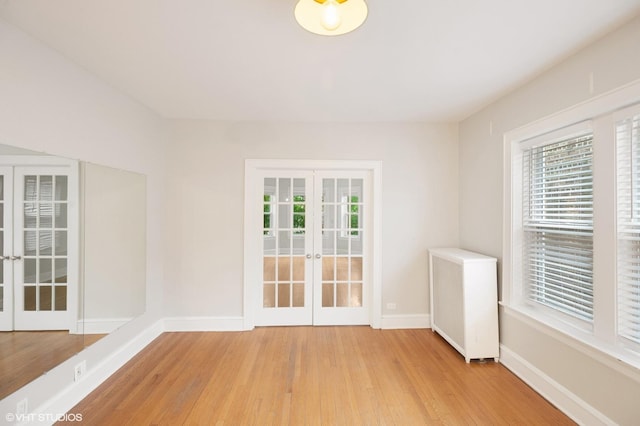 1620 W Olive Ave Unit 3A, Chicago, IL 60660 - empty room featuring french doors, light wood-style floors, and plenty of natural light