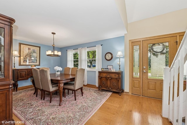 862 Wimbleton Ln, Crystal Lake, IL 60014 - dining area with light wood-style floors, a chandelier, stairs, and baseboards