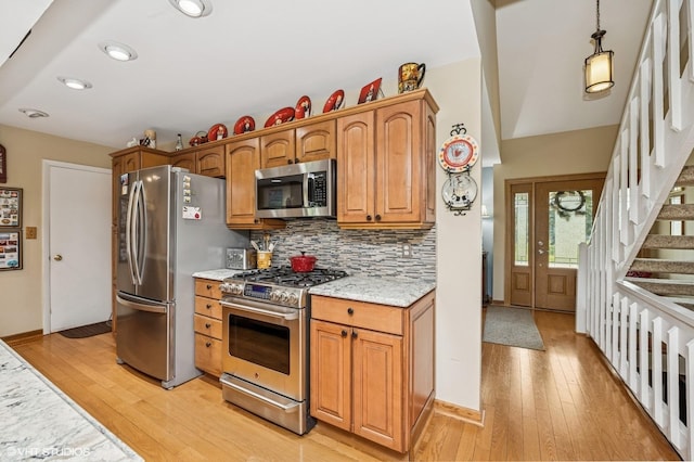 862 Wimbleton Ln, Crystal Lake, IL 60014 - kitchen with appliances with stainless steel finishes, light wood-style flooring, backsplash, recessed lighting, and light stone counters