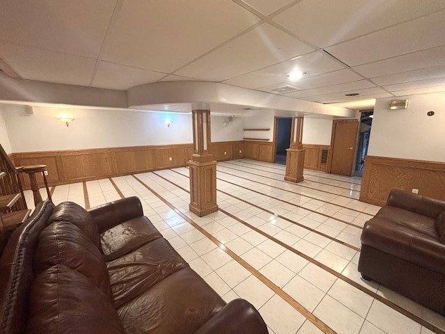 1 Marlin Dr, Oswego, IL 60543 - finished basement featuring a wainscoted wall, a drop ceiling, light tile patterned floors, and inlaid floor details