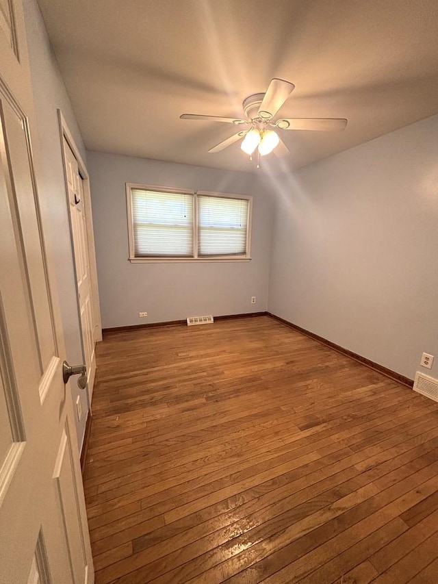1 Marlin Dr, Oswego, IL 60543 - unfurnished bedroom with hardwood / wood-style flooring, a ceiling fan, and baseboards