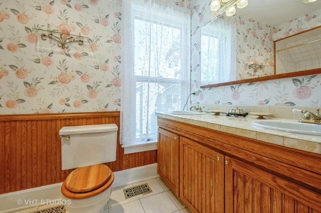 128 Forest Ave, Riverside, IL 60546 - bathroom with wallpapered walls, plenty of natural light, tile patterned floors, double vanity, and toilet