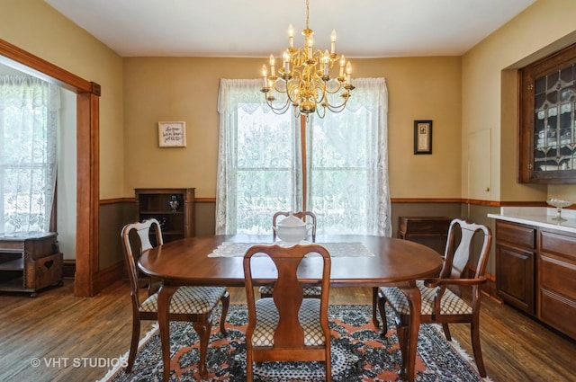 128 Forest Ave, Riverside, IL 60546 - dining space featuring dark wood-type flooring, a chandelier, and a wainscoted wall