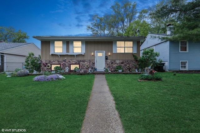 2110 Hermon Ave, Zion, IL 60099 - split foyer home with board and batten siding, a front lawn, and stone siding
