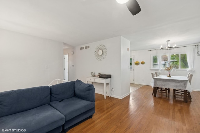 2110 Hermon Ave, Zion, IL 60099 - living area featuring a chandelier, a ceiling fan, wood-type flooring, and baseboards