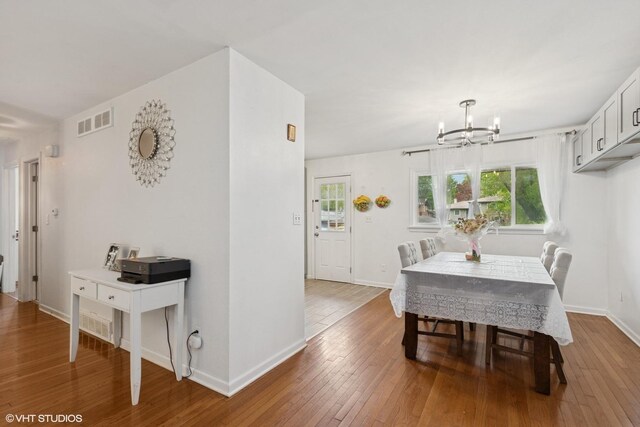 2110 Hermon Ave, Zion, IL 60099 - dining space featuring a chandelier, hardwood / wood-style floors, and baseboards