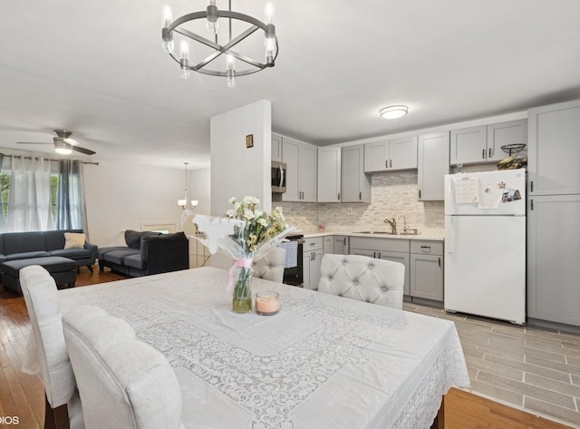 2110 Hermon Ave, Zion, IL 60099 - dining area with a chandelier and a ceiling fan