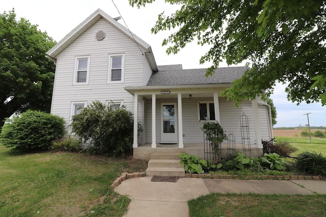 4977 N Mount Vernon Rd, Forreston, IL 61030 - view of front of home featuring covered porch, a front yard, and a shingled roof