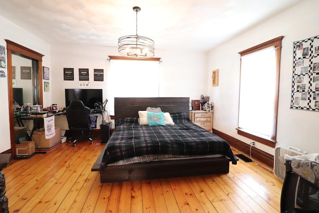 4977 N Mount Vernon Rd, Forreston, IL 61030 - bedroom featuring an office area, light wood-style floors, and a chandelier