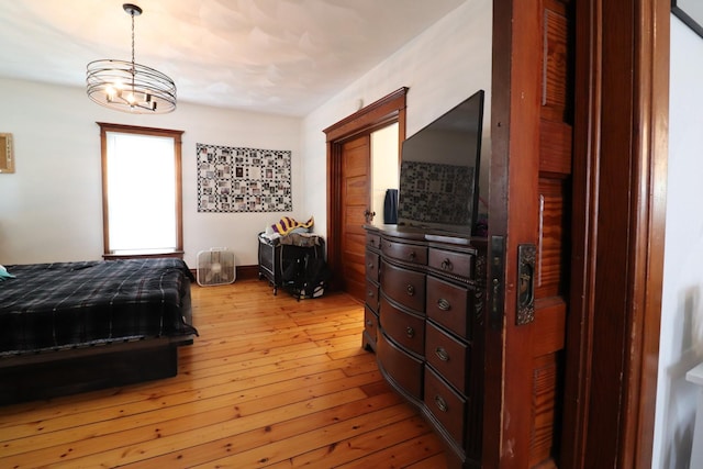 4977 N Mount Vernon Rd, Forreston, IL 61030 - bedroom featuring light wood-style floors and a chandelier