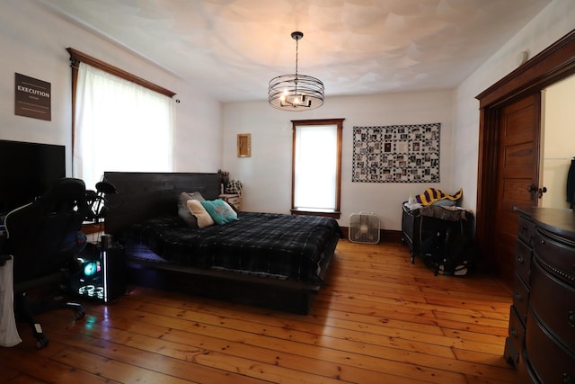 4977 N Mount Vernon Rd, Forreston, IL 61030 - bedroom with wood-type flooring and a chandelier