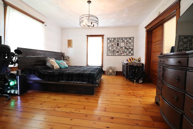 4977 N Mount Vernon Rd, Forreston, IL 61030 - bedroom featuring light wood-type flooring and a chandelier