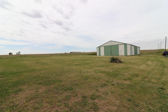 4977 N Mount Vernon Rd, Forreston, IL 61030 - view of grassy yard featuring an outbuilding, an outdoor structure, and a garage