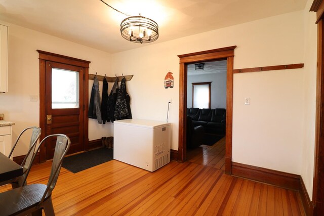 4977 N Mount Vernon Rd, Forreston, IL 61030 - dining area with a chandelier, light wood-type flooring, and baseboards