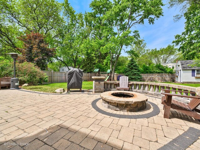 421 S River Rd, Naperville, IL 60540 - fenced backyard with an outdoor fire pit and a patio area