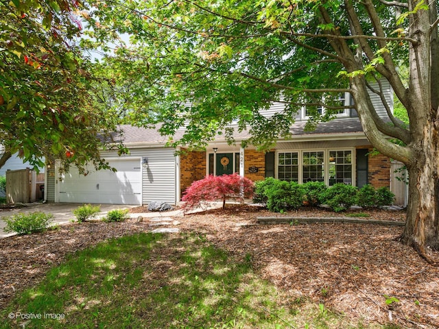 421 S River Rd, Naperville, IL 60540 - view of property hidden behind natural elements with driveway, an attached garage, and brick siding