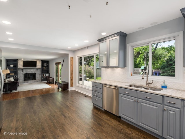 421 S River Rd, Naperville, IL 60540 - kitchen with gray cabinets, dishwasher, a sink, a large fireplace, and dark wood-style floors