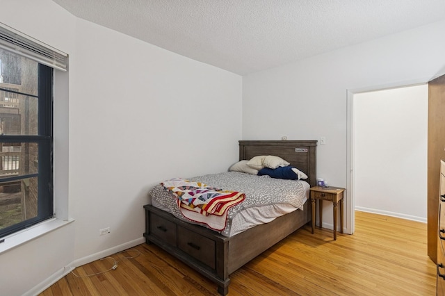 5337 S Ellis Ave Unit 1C, Chicago, IL 60615 - bedroom with light wood-style flooring, baseboards, and a textured ceiling