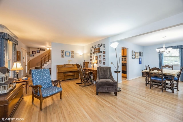1005 69th St, Darien, IL 60561 - living area featuring light wood-type flooring, a chandelier, stairs, baseboards, and beam ceiling