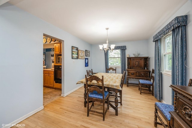 1005 69th St, Darien, IL 60561 - dining area with a chandelier, light wood-type flooring, and baseboards