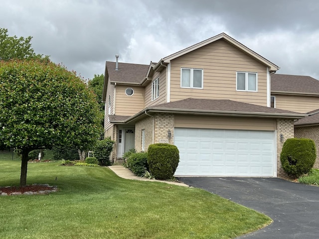 7750 Northfield Ln, Tinley Park, IL 60487 - traditional home with an attached garage, driveway, brick siding, a front lawn, and a shingled roof