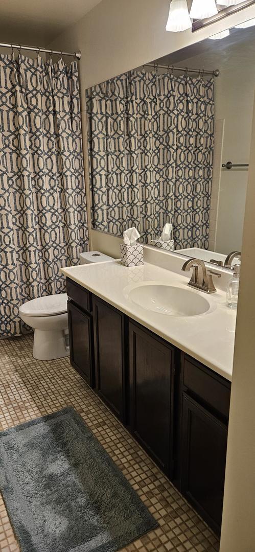 973 Willowbrook Dr, Wheeling, IL 60090 - full bath featuring vanity, toilet, tile patterned floors, and a shower with curtain
