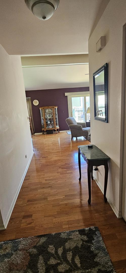 973 Willowbrook Dr, Wheeling, IL 60090 - corridor featuring wood finished floors and baseboards