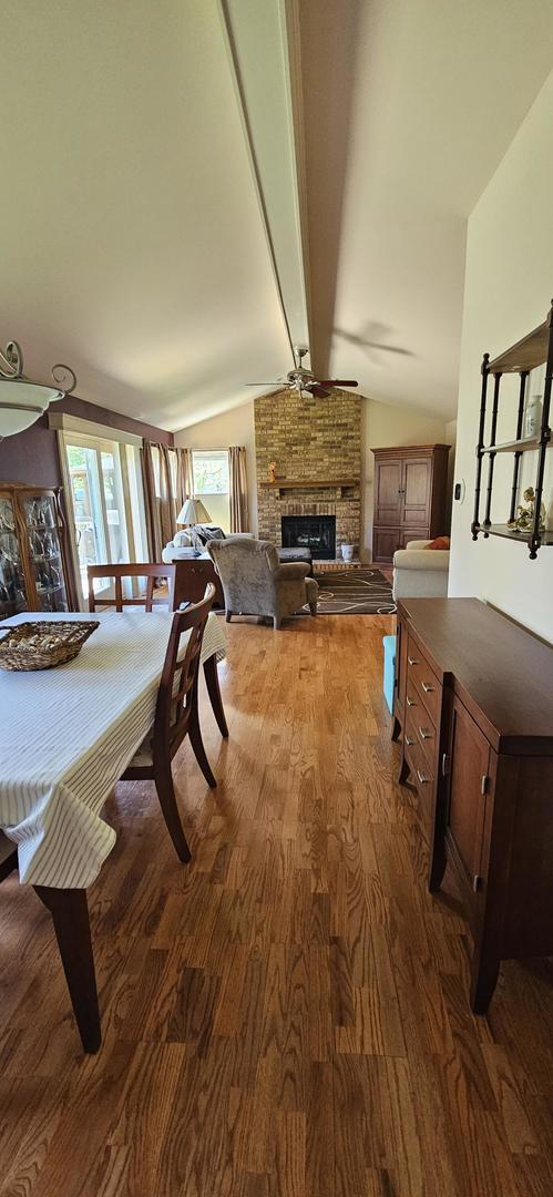 973 Willowbrook Dr, Wheeling, IL 60090 - bedroom featuring dark wood-style floors and a brick fireplace