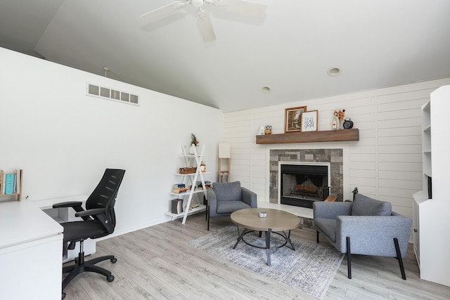 413 W Cook St, Manteno, IL 60950 - home office featuring wood finished floors, a ceiling fan, vaulted ceiling, a stone fireplace, and baseboards