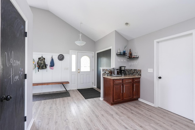 413 W Cook St, Manteno, IL 60950 - bar with light wood finished floors, high vaulted ceiling, and pendant lighting